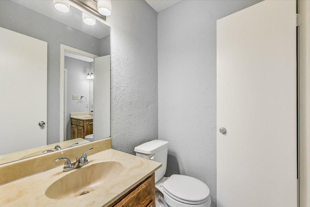 317 W William Cannon Dr B, Unit A, Austin, TX 78745 - bathroom featuring a textured wall and vanity
