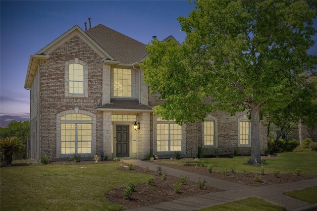 6611 Yaupon Dr, Austin, TX 78759 - view of front of house featuring a front lawn, brick siding, and a shingled roof