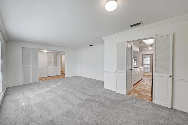 1700 Barton Hills Dr, Austin, TX 78704 - unfurnished bedroom with crown molding, light carpet, and ensuite bath