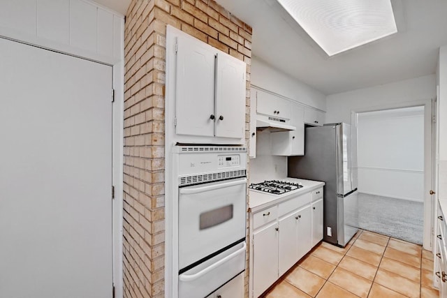 1700 Barton Hills Dr, Austin, TX 78704 - kitchen featuring white oven, gas cooktop, white cabinetry, a warming drawer, and under cabinet range hood