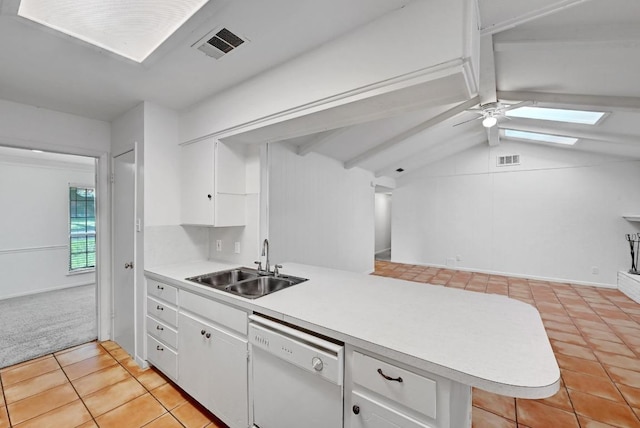 1700 Barton Hills Dr, Austin, TX 78704 - kitchen featuring dishwasher, light tile patterned floors, a peninsula, light countertops, and white cabinetry