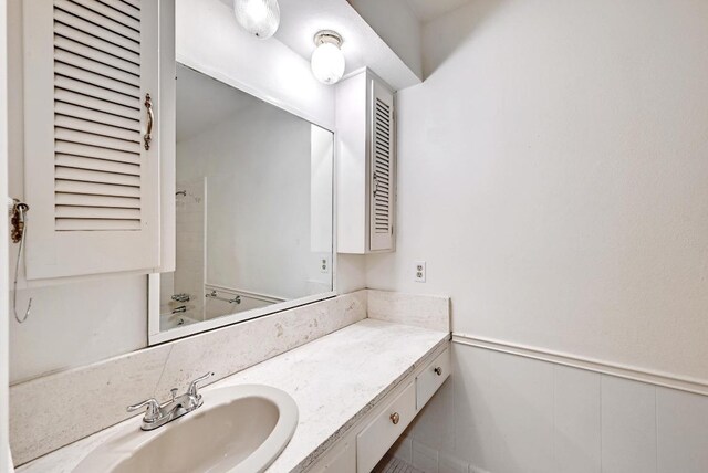 1700 Barton Hills Dr, Austin, TX 78704 - full bathroom with vanity and a wainscoted wall