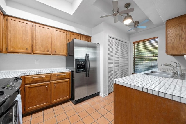 8200 Neely Dr Unit 103, Austin, TX 78759 - kitchen with stainless steel refrigerator with ice dispenser, a sink, black range, ceiling fan, and tile countertops
