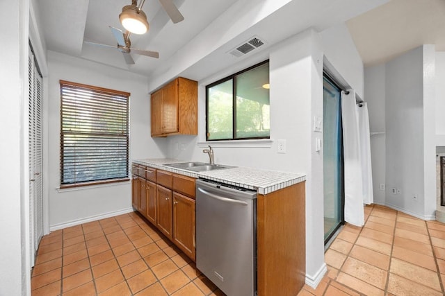 8200 Neely Dr Unit 103, Austin, TX 78759 - kitchen featuring stainless steel dishwasher, a sink, ceiling fan, light countertops, and brown cabinets