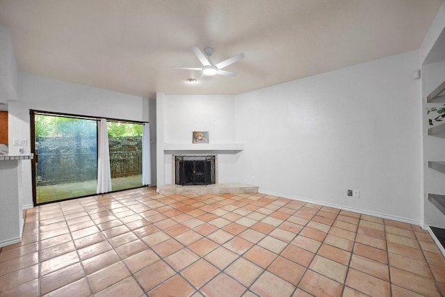 8200 Neely Dr Unit 103, Austin, TX 78759 - unfurnished living room featuring a tile fireplace and ceiling fan