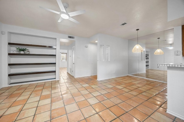 8200 Neely Dr Unit 103, Austin, TX 78759 - unfurnished living room with a ceiling fan, built in features, light tile patterned floors, and baseboards