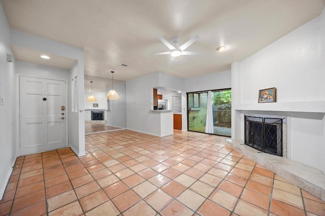8200 Neely Dr Unit 103, Austin, TX 78759 - unfurnished living room with a fireplace with raised hearth, a ceiling fan, baseboards, recessed lighting, and light tile patterned floors
