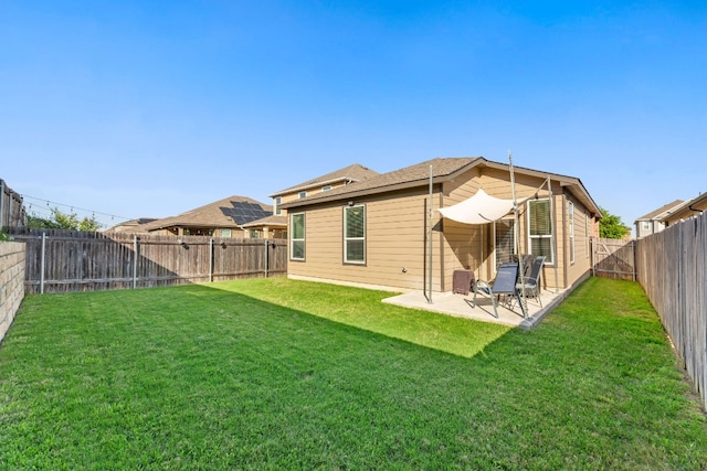 rear view of house with a patio area, a fenced backyard, and a yard