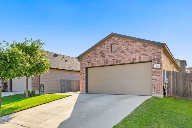 ranch-style house featuring a front yard, fence, brick siding, an attached garage, and concrete driveway