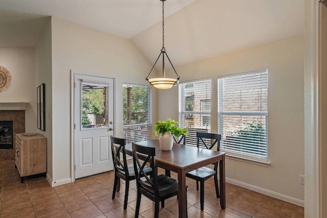 3610 Turkey Path Bnd, Cedar Park, TX 78613 - dining room featuring plenty of natural light, vaulted ceiling, tile patterned flooring, and a tiled fireplace
