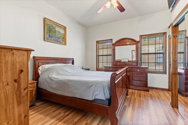 406 Garwood St, Smithville, TX 78957 - bedroom with light wood-style flooring, baseboards, and a ceiling fan