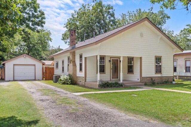 406 Garwood St, Smithville, TX 78957 - view of front of property with a chimney, an outbuilding, driveway, central air condition unit, and a detached garage