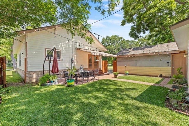 406 Garwood St, Smithville, TX 78957 - rear view of property with a patio and a yard