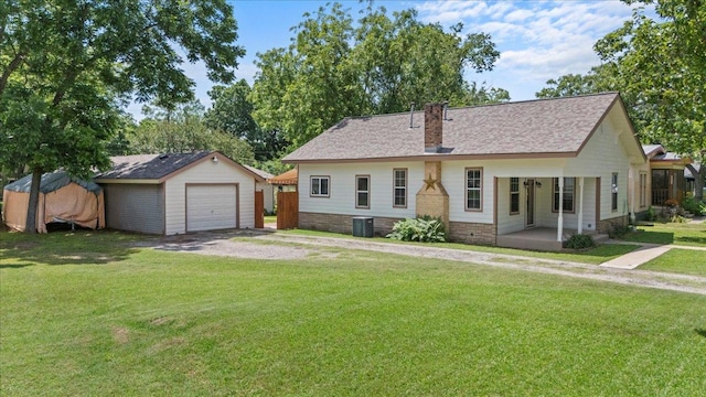 406 Garwood St, Smithville, TX 78957 - ranch-style home with an outdoor structure, a detached garage, central AC unit, driveway, and a front yard