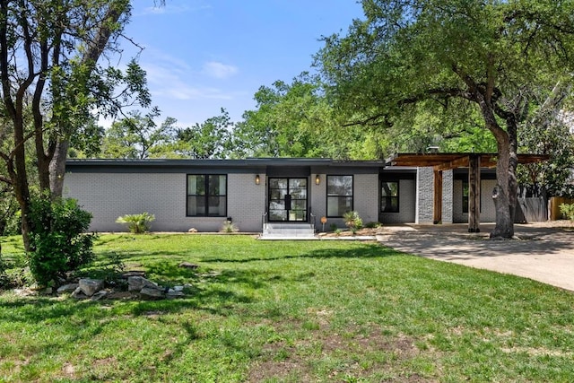 104 Westhaven Dr, West Lake Hills, TX 78746 - back of house with driveway, brick siding, and a yard