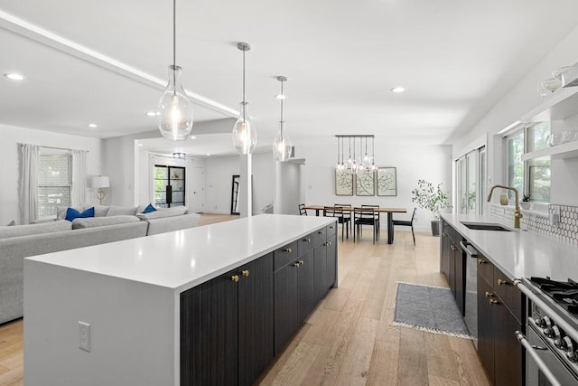 104 Westhaven Dr, West Lake Hills, TX 78746 - kitchen with high end range, a kitchen island, recessed lighting, light countertops, and light wood-style floors