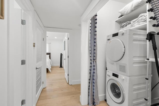 104 Westhaven Dr, West Lake Hills, TX 78746 - washroom with stacked washing machine and dryer, light wood finished floors, and recessed lighting