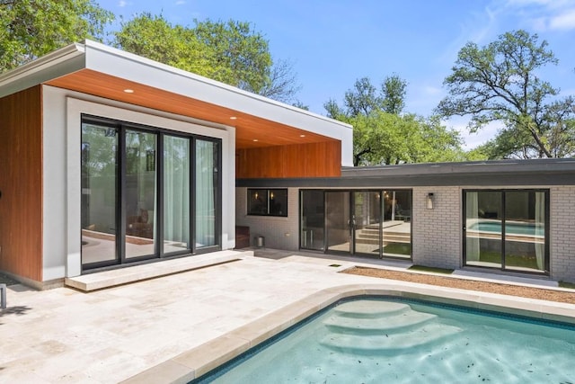 104 Westhaven Dr, West Lake Hills, TX 78746 - back of house featuring a patio area, an outdoor pool, and brick siding