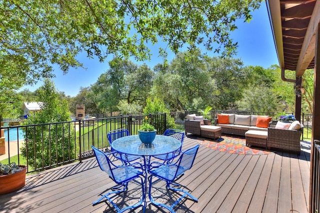 wooden terrace featuring an outdoor living space and outdoor dining area