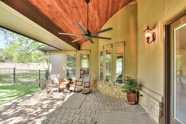 view of patio with fence and a ceiling fan
