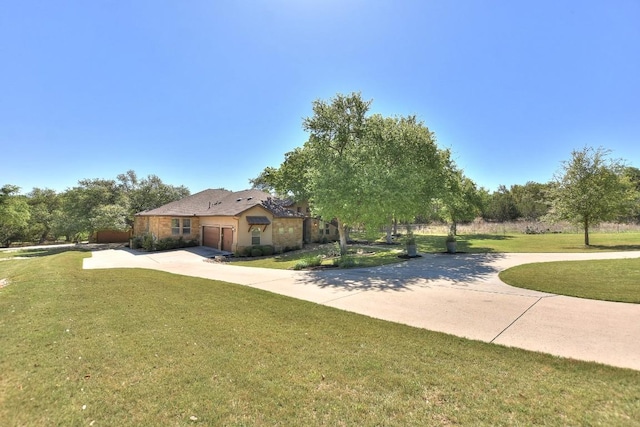 view of yard with driveway and a garage