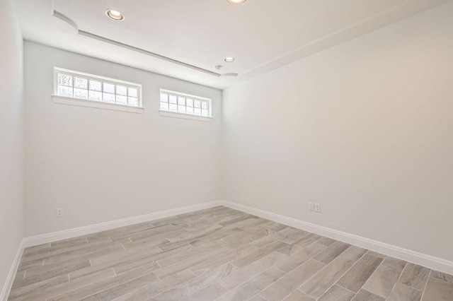 spare room featuring recessed lighting, light wood-style floors, and a healthy amount of sunlight