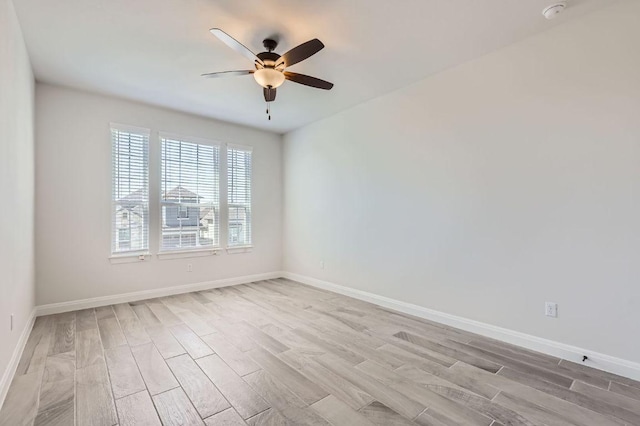 unfurnished room with light wood finished floors, baseboards, and ceiling fan