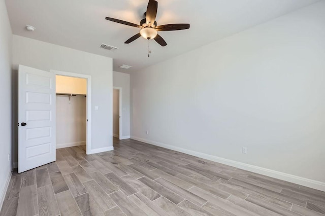 unfurnished bedroom featuring light wood-style flooring, baseboards, and visible vents