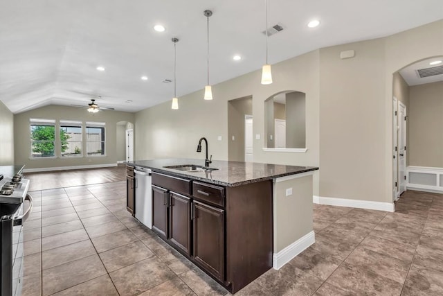 3613 Esperanza Dr, Round Rock, TX 78665 - kitchen with a sink, arched walkways, appliances with stainless steel finishes, dark brown cabinets, and vaulted ceiling