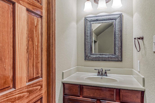 bathroom featuring vanity and a textured wall