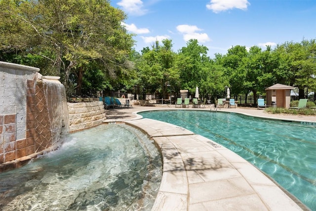 11203 Ranch Road 2222 1105, Austin, TX 78730 - view of swimming pool featuring a patio, a pool with connected hot tub, and view of scattered trees
