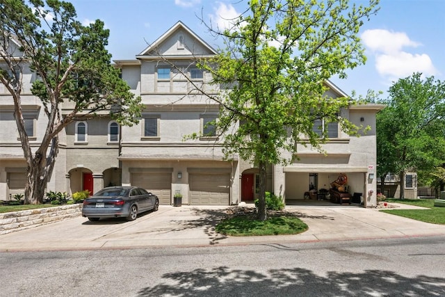 11203 Ranch Road 2222 1105, Austin, TX 78730 - townhome / multi-family property featuring driveway, an attached garage, and stucco siding