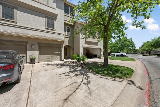 11203 Ranch Road 2222 1105, Austin, TX 78730 - view of front of property with concrete driveway, stucco siding, and an attached garage