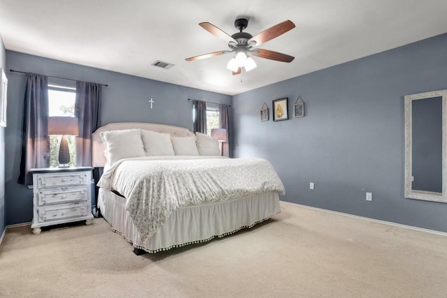 bedroom featuring light carpet, baseboards, a ceiling fan, and visible vents