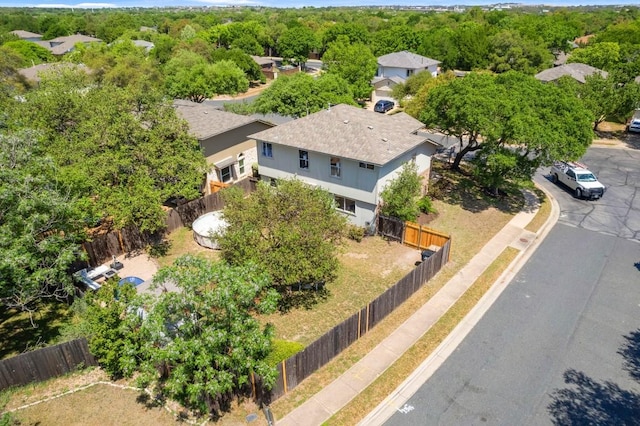 birds eye view of property featuring a view of trees