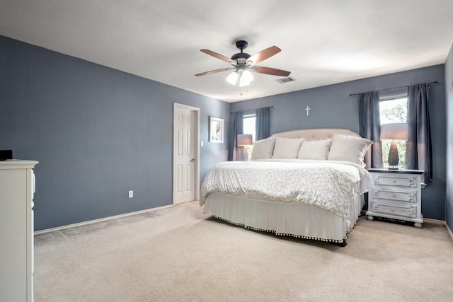 bedroom featuring carpet flooring, visible vents, baseboards, and a ceiling fan