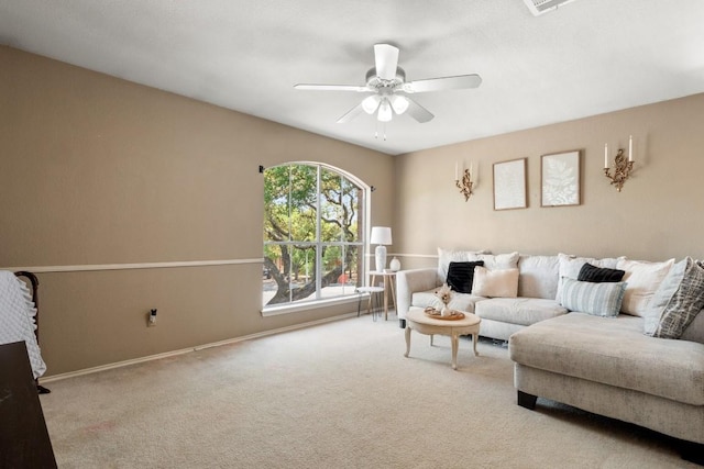 carpeted living room with baseboards and a ceiling fan