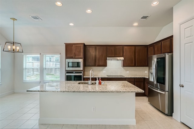 504 Pinnacle View Dr, Georgetown, TX 78628 - kitchen featuring appliances with stainless steel finishes, a sink, under cabinet range hood, tasteful backsplash, and light stone countertops