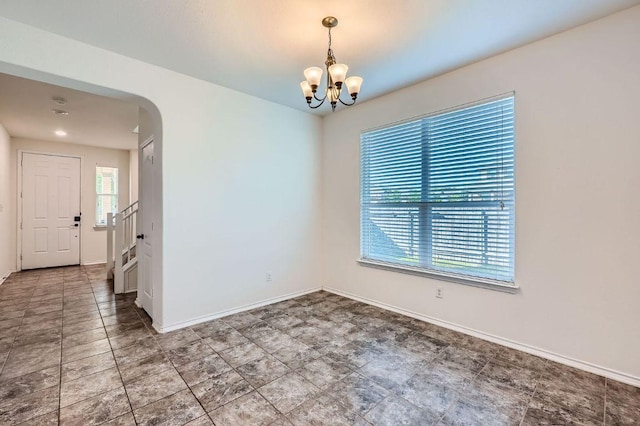 1161 Verna Brooks Way, Kyle, TX 78640 - empty room with arched walkways, a chandelier, baseboards, and stairway