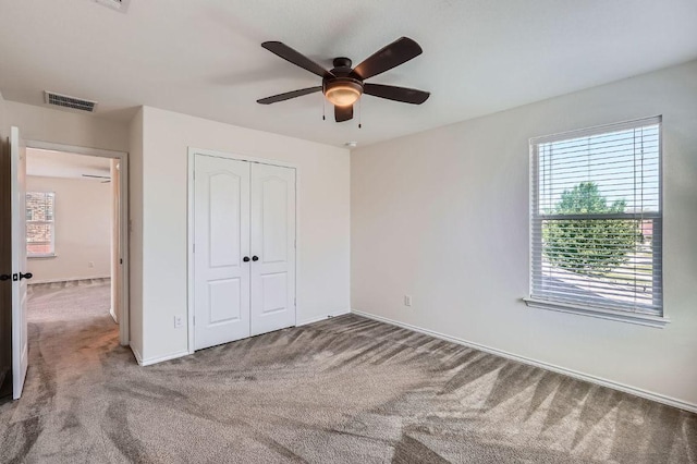 1161 Verna Brooks Way, Kyle, TX 78640 - unfurnished bedroom with carpet, multiple windows, a closet, and baseboards