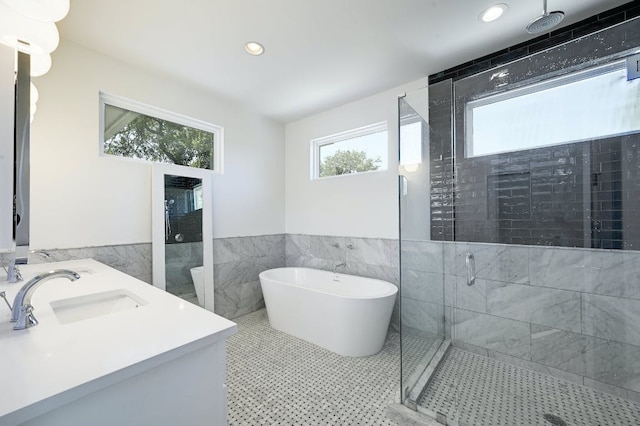 903 W Gibson St, Austin, TX 78704 - full bathroom with tile walls, a stall shower, a freestanding bath, wainscoting, and recessed lighting