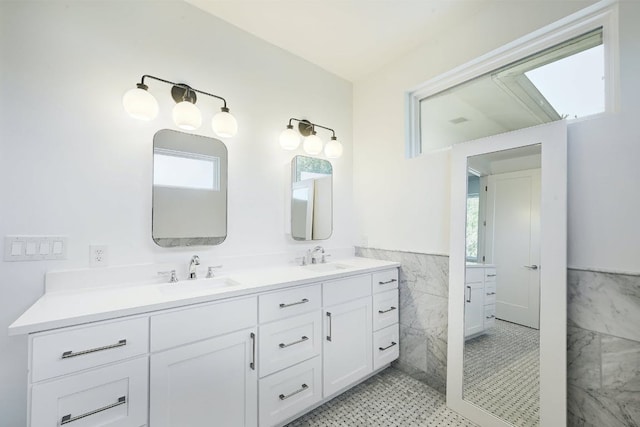903 W Gibson St, Austin, TX 78704 - full bathroom featuring double vanity, tile walls, and wainscoting