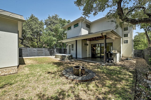 903 W Gibson St, Austin, TX 78704 - rear view of property with a fire pit, stucco siding, a patio, and a ceiling fan