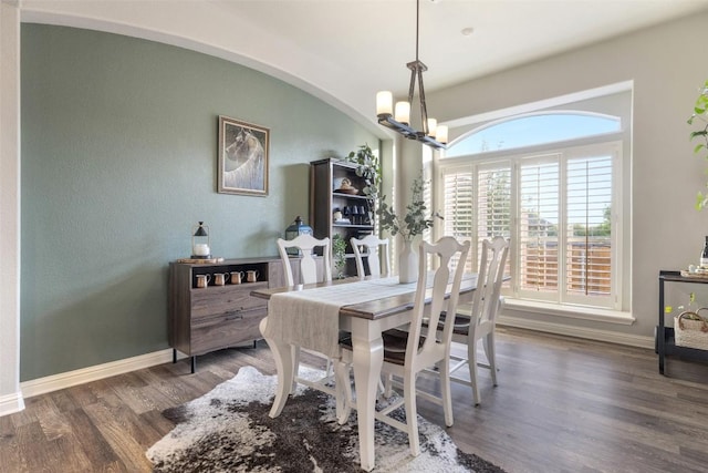 1218 Swenson Farms Blvd, Pflugerville, TX 78660 - dining area with a chandelier, wood finished floors, arched walkways, and baseboards