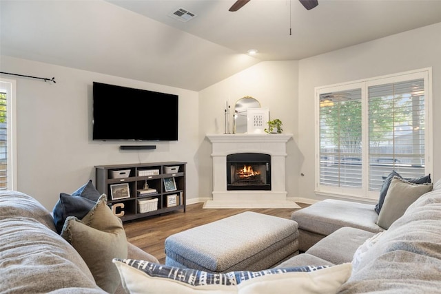 1218 Swenson Farms Blvd, Pflugerville, TX 78660 - living area featuring ceiling fan, wood finished floors, vaulted ceiling, a warm lit fireplace, and baseboards