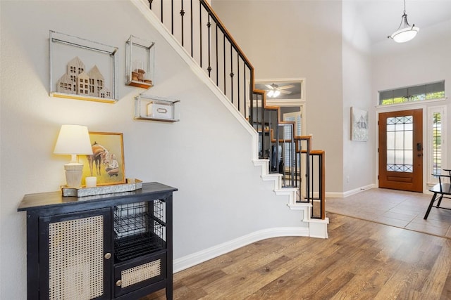 1218 Swenson Farms Blvd, Pflugerville, TX 78660 - foyer entrance with a towering ceiling, wood finished floors, stairs, baseboards, and a ceiling fan