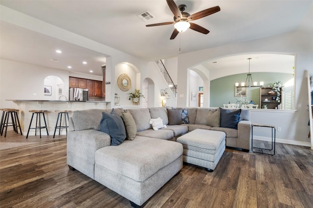1218 Swenson Farms Blvd, Pflugerville, TX 78660 - living area with arched walkways, dark wood-type flooring, a ceiling fan, a chandelier, and recessed lighting