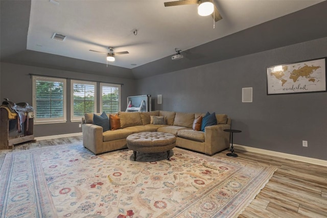 1218 Swenson Farms Blvd, Pflugerville, TX 78660 - living room featuring a ceiling fan, wood finished floors, baseboards, and a raised ceiling