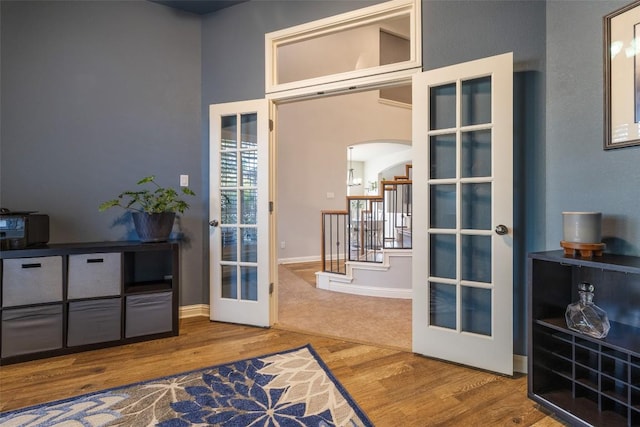 1218 Swenson Farms Blvd, Pflugerville, TX 78660 - entryway with french doors, arched walkways, wood finished floors, baseboards, and stairs