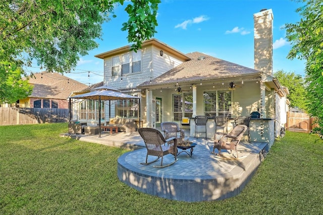 1218 Swenson Farms Blvd, Pflugerville, TX 78660 - rear view of property featuring ceiling fan, a gazebo, a patio, a chimney, and an outdoor hangout area